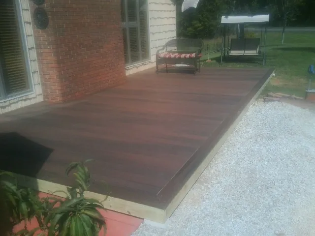 Freshly stained wood deck built against a brick home in South Lake Tahoe