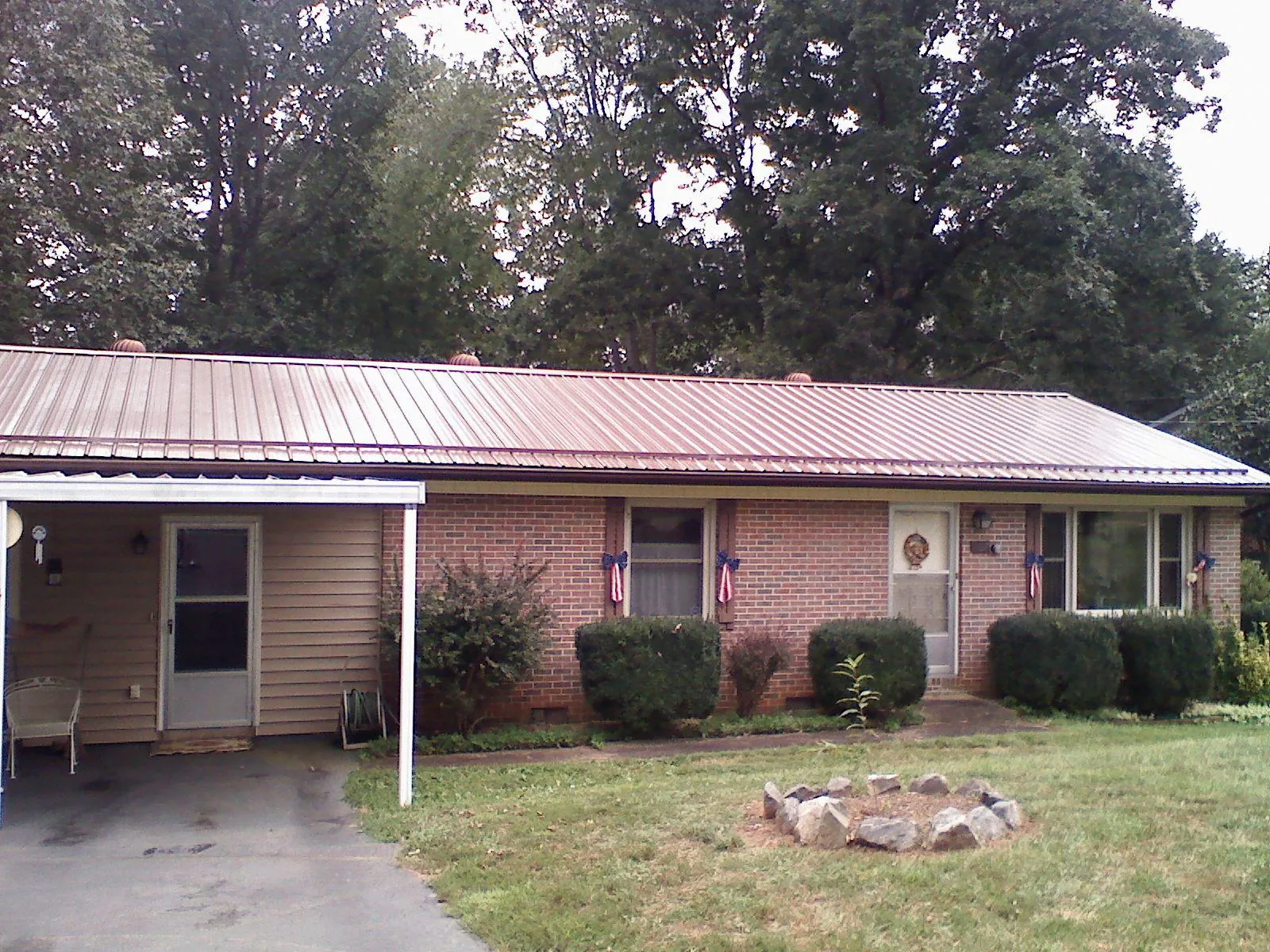 Bronze metal roof and carport on a brick ranch home — Roof Repair work by our crew in South Lake Tahoe